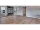 Open living room with a gray tile fireplace and light wood flooring at 8581 Eckley St, Littleton, CO 80125