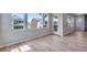 Living room showcasing large windows, a glass door, and wood flooring at 8581 Eckley St, Littleton, CO 80125
