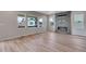 Bright living room featuring an electric fireplace, lots of windows, and light wood flooring at 8581 Eckley St, Littleton, CO 80125