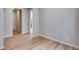 Bright living room featuring wood floors, neutral paint, and white trim at 8581 Eckley St, Littleton, CO 80125