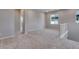 Spacious loft area featuring neutral carpet and access to multiple rooms at 8581 Eckley St, Littleton, CO 80125