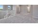 Second floor loft area featuring neutral carpet and railing overlooking the staircase at 8581 Eckley St, Littleton, CO 80125