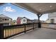 Outdoor porch with black wood railings overlooking the backyard at 8581 Eckley St, Littleton, CO 80125
