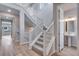 Bright open staircase featuring white railings and grey carpet on the stairs at 8581 Eckley St, Littleton, CO 80125