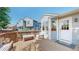 Cozy back deck with wooden floor, bench seating and chairs, perfect for enjoying outdoor living at 11560 River Run Cir, Commerce City, CO 80640