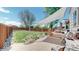 Large backyard with grass, patio area, shade cover, wooden fence and landscaping at 11560 River Run Cir, Commerce City, CO 80640