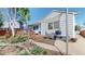 Charming backyard patio with shade sail, greenery, and easy access to the deck at 11560 River Run Cir, Commerce City, CO 80640
