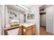 Stylish bathroom boasts a bright vanity, modern lighting and decorative storage at 11560 River Run Cir, Commerce City, CO 80640