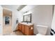 Bright bathroom featuring wood cabinets, stylish vanity, and tile floors at 11560 River Run Cir, Commerce City, CO 80640