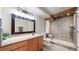 Well-lit bathroom featuring stylish vanity and walk in shower with built-in seat at 11560 River Run Cir, Commerce City, CO 80640