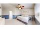 Comfortable bedroom with soft lighting, a ceiling fan, and stylish decor at 11560 River Run Cir, Commerce City, CO 80640