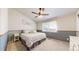 Serene bedroom featuring neutral colors, plush carpeting, and a large window at 11560 River Run Cir, Commerce City, CO 80640