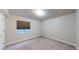 Minimalist bedroom featuring carpet, a bright window and neutral decor at 11560 River Run Cir, Commerce City, CO 80640