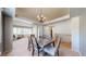 Elegant dining area with an ornate chandelier, a rustic table, and carpet flooring at 11560 River Run Cir, Commerce City, CO 80640