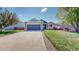 Inviting home showcasing a well-maintained lawn and a two-car garage at 11560 River Run Cir, Commerce City, CO 80640