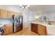 Well-equipped kitchen with stainless steel appliances and natural wood cabinetry at 11560 River Run Cir, Commerce City, CO 80640