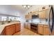 Modern kitchen featuring stainless steel appliances and hardwood flooring at 11560 River Run Cir, Commerce City, CO 80640