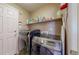 Laundry room featuring modern washer and dryer units and ample storage space at 11560 River Run Cir, Commerce City, CO 80640
