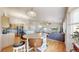 Open concept floor plan featuring a dining area open to the kitchen and cozy living room at 11560 River Run Cir, Commerce City, CO 80640