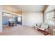 Bright living space featuring a large window, modern chair, and dining area at 11560 River Run Cir, Commerce City, CO 80640