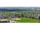 An aerial view of a Gathering-friendly neighborhood including parks, baseball field and a play area at 11560 River Run Cir, Commerce City, CO 80640