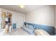 Bright playroom includes a cozy blue couch and playful design elements at 11560 River Run Cir, Commerce City, CO 80640