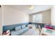 Inviting playroom with a comfy blue couch and whimsical decor, perfect for  at 11560 River Run Cir, Commerce City, CO 80640