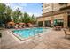 Resort-style pool with lounge chairs and umbrellas at 5455 Landmark Pl # 604, Greenwood Village, CO 80111