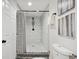 Clean bathroom with glass-enclosed shower and marble tiles at 1461 Hickory Ct, Erie, CO 80516