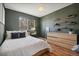 Stylish bedroom with hardwood floors, wooden dresser, and designer-selected decor at 1461 Hickory Ct, Erie, CO 80516