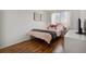 Well-lit bedroom with hardwood floors, large window, and modern decor at 1461 Hickory Ct, Erie, CO 80516