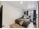 Clean bedroom with a bed, window with curtains, and minimalistic decor at 1461 Hickory Ct, Erie, CO 80516