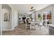 A bright dining area with wood floors, a rustic dining table set, and large sliding glass doors to the patio at 1461 Hickory Ct, Erie, CO 80516