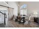 Dining area features a modern table with a wooden bench, large windows, and stylish decor at 1461 Hickory Ct, Erie, CO 80516