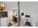 Small kitchenette area including sink, microwave, dining table, and decorative zebra art at 1461 Hickory Ct, Erie, CO 80516