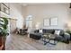 Bright open-concept living room featuring high ceilings, a barn door, and modern furniture at 1461 Hickory Ct, Erie, CO 80516
