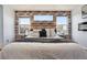 Stylish main bedroom with three windows, decorative brick wall, and a modern fireplace at 1461 Hickory Ct, Erie, CO 80516
