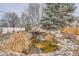 Backyard pond with small waterfall surrounded by lush landscaping and greenery at 8208 Tabor Ct, Arvada, CO 80005