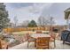 Spacious backyard features a patio, mature trees, and a well-maintained lawn at 8208 Tabor Ct, Arvada, CO 80005