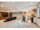 Finished basement has comfortable living area, kitchenette, and neutral carpeting at 8208 Tabor Ct, Arvada, CO 80005