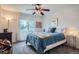 Well-lit carpeted bedroom with a comfortable bed, large window, and stylish decor at 8208 Tabor Ct, Arvada, CO 80005