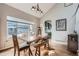 An airy dining room features hardwood floors and lots of natural light at 8208 Tabor Ct, Arvada, CO 80005