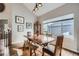 Dining room with wooden floors and table next to a large window providing plenty of natural light at 8208 Tabor Ct, Arvada, CO 80005