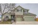 Charming two-story home features a landscaped yard and a three car garage at 8208 Tabor Ct, Arvada, CO 80005