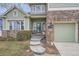 Inviting front entrance with stone steps and a well-manicured landscape at 8208 Tabor Ct, Arvada, CO 80005