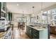 Well-lit kitchen with updated cabinets, granite countertops, stainless appliances, and an open layout at 8208 Tabor Ct, Arvada, CO 80005