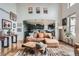 Cozy living room with hardwood floors, stylish furniture, and an open view to the adjacent kitchen at 8208 Tabor Ct, Arvada, CO 80005