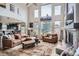 Bright living room with large windows, a fireplace, and wood floors at 8208 Tabor Ct, Arvada, CO 80005