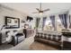 Spacious main bedroom with a ceiling fan, carpet, and a comfortable bed with ample natural light at 8208 Tabor Ct, Arvada, CO 80005