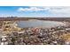 Stunning aerial view of the property with a lake nearby and the city skyline in the distance at 2430 Ames St, Edgewater, CO 80214